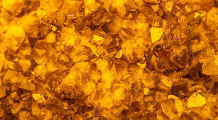 Golden crystal mineral stone. Gems. Mineral crystals in the natural environment. Texture of precious and semiprecious stones. Seamless background with copy space.