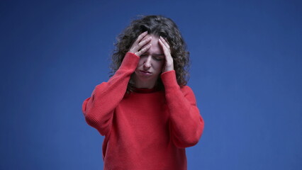 Woman covering face with regret, anxious preoccupied 20s person feeling anguish and annoyance...