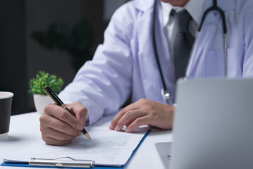 doctor holds a pen and writes notes on examinations, medical history of patients. medical prescription