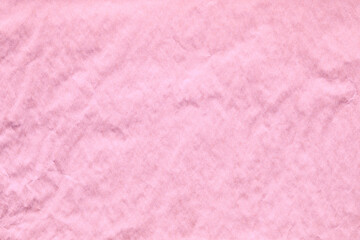 pink crumpled paper texture with grains macro closeup