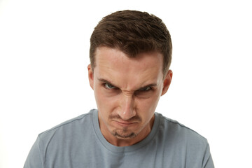 Fototapeta premium angry guy looking at camera on white studio background
