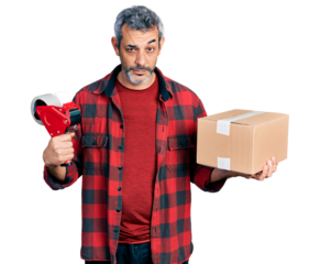 Middle age hispanic with grey hair holding packing tape and cardboard box skeptic and nervous, frowning upset because of problem. negative person.