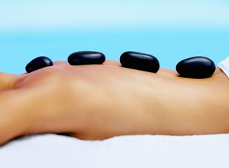 Spa, woman back and hot stone massage outdoor for wellness, healing and stress relief body...