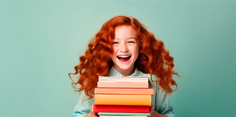 Young cute girl red hair. A young girl in holds an book in her hands on a color background. Banner dot, place for text.