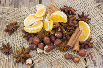 cinnamon sticks, star anise spices, tangerine and nuts - christmas time