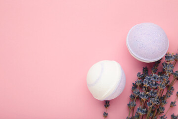 Natural cosmetics. Handmade lavender bath bombs and lavender flowers on pink background. Top view