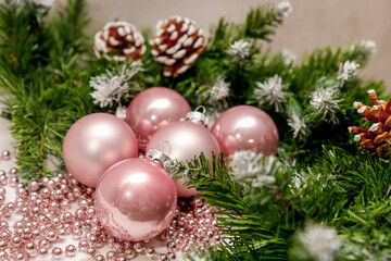 Fototapeta na wymiar pink New Year balls with fir branches and pine cones, New Year, Christmas background