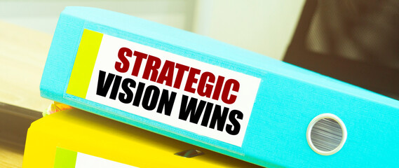 Two office folders with text STRATEGIC VISION WINS