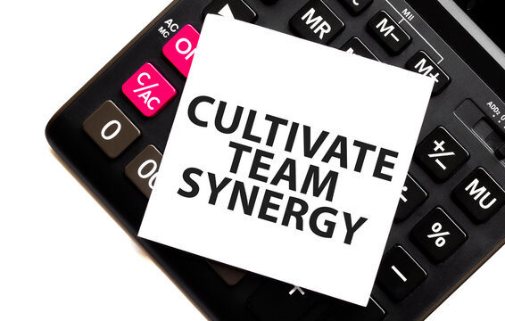CULTIVATE TEAM SYNERGY on white sticker and calculator on white background