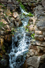 Waterfall falling in a flowing creek park