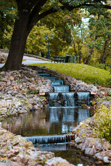 Naklejka premium Waterfall falling in a flowing creek park