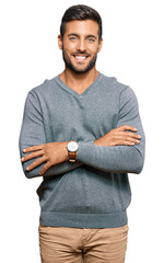 Handsome hispanic man wearing casual clothes happy face smiling with crossed arms looking at the...
