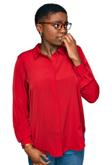 Young african american woman wearing casual clothes and glasses looking stressed and nervous with hands on mouth biting nails. anxiety problem.