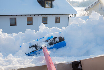 remove a lot of snow from the roof window with the snow shovel