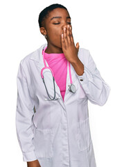 Young african american woman wearing doctor uniform and stethoscope bored yawning tired covering mouth with hand. restless and sleepiness.