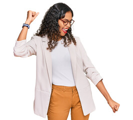 Young african american girl wearing business clothes dancing happy and cheerful, smiling moving casual and confident listening to music