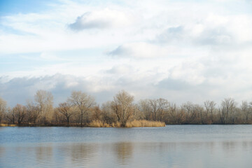 Sad autumn river landscape with cloudy sky