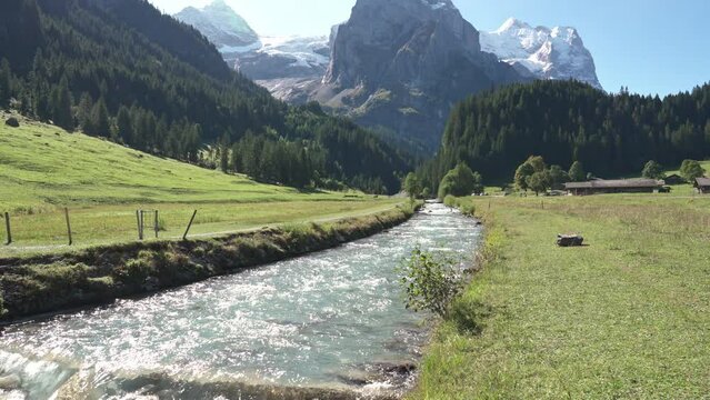Swiss Alps view of Rosenlaui with Wellhorn and Reichenbach river in summer at Switzerland