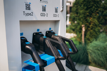 Close Up EV charging at station. Eco and clean energy concept. Efficient Electric Car Charging...
