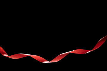 Red ribbon isolated on black background