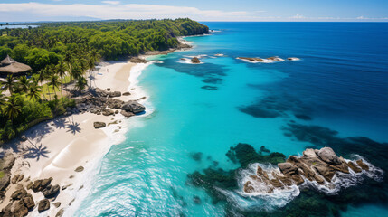 Fototapeta premium A bird's-eye perspective of a verdant shoreline with sparkling azure waves, fair sand, and striking coral reefs.