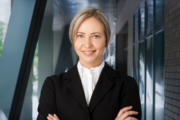 Young business woman standing in city street