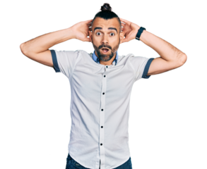 Hispanic man with ponytail wearing casual white shirt crazy and scared with hands on head, afraid and surprised of shock with open mouth