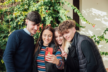 Joyful group of friends taking selfie