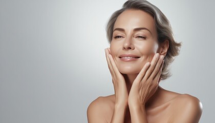 Happy middle-aged  woman posing on white background, touching face, Portrait of sophisticated senior woman advertising beauty products and services