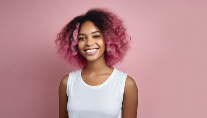 Smiling Afro-American model with pink curly hair on a pink background