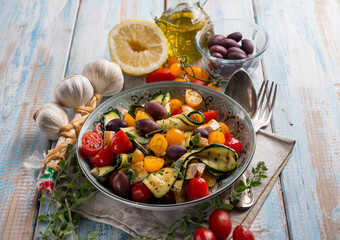 chicken salad with zucchinis cherry tomatoes black olives and lemon