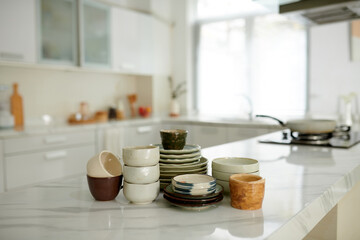 Ceramic bowls, plates and cups on kitchen counter