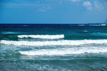 Greece, ripple dark sea water, splashing foam, Greek blue sky background, copy space. Ad template