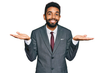 Young african american man wearing business clothes clueless and confused expression with arms and hands raised. doubt concept. - obrazy, fototapety, plakaty