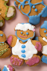 Christmas gingerbread in the shape of men decorated with colorful icing, top view