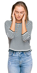 Fototapeta premium Beautiful blonde woman wearing casual clothes with hand on head for pain in head because stress. suffering migraine.