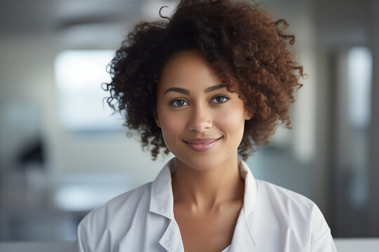 Portrait of a young woman doctor, closeup of a smiling Afro American physician wearing medical coat 