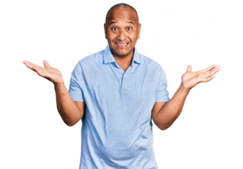 Hispanic middle age man wearing casual t shirt celebrating victory with happy smile and winner expression with raised hands