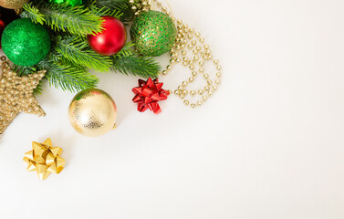 Christmas background with fir branches, red and gold decorations on a white background. Flat lay. top view with copy space