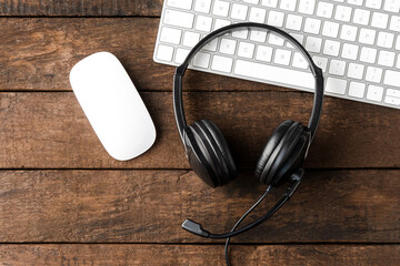 Call center desktop with headphones and computer. Top view