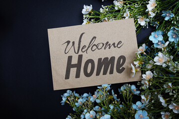 Welcome Home text message with flower decoration on black background