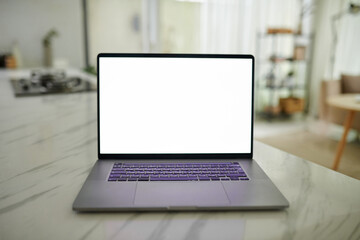 Laptop with white screen on marble kitchen counter