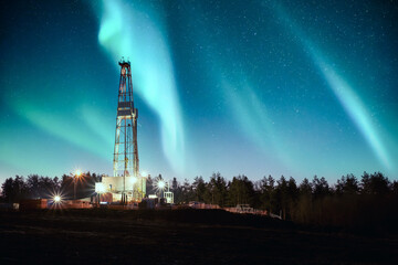 Aurora borealis Northern lights over oil gas drilling rig. Industrial concept