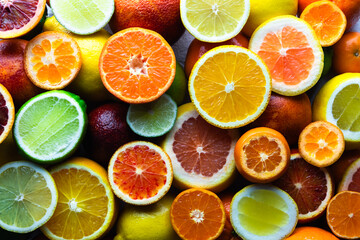 A close-up arrangement of assorted citrus fruits, embodying the concept of a nutritious and vitamin-rich diet. Food background. Natural texture