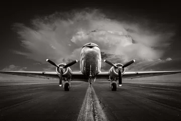 Photo sur Plexiglas Ancien avion historical aircraft on a runway against a dramatic sky