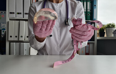 Plastic surgeon measures breast implants with measuring tape