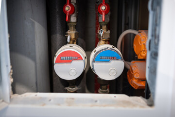 Water meters for hot and cold water in an apartment. The consumption for the household can be read...