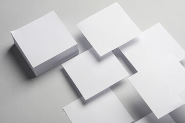 Composition of floating white square memo papers on gray background. Business concept - obrazy, fototapety, plakaty