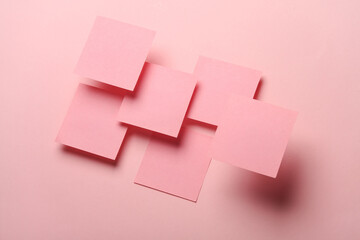 Composition of floating pink square memo papers on pink background. Business concept