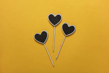 Chalkboard labels, blank wooden blackboard tags, heart shaped garden sign on yellow background